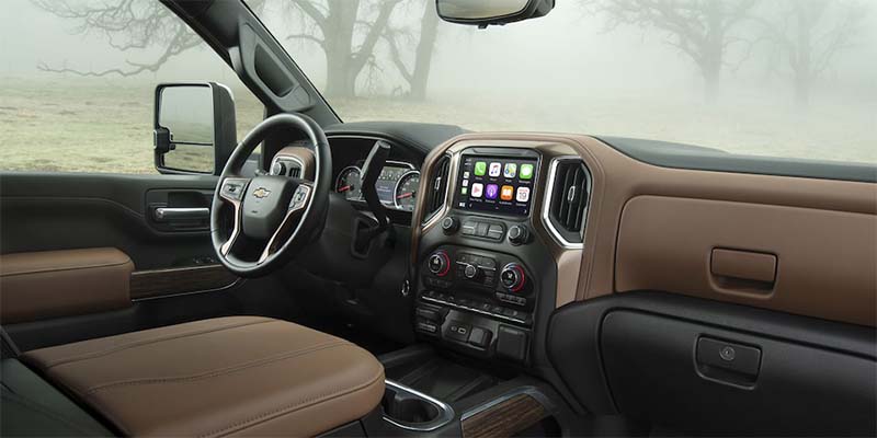 Interior view of a truck with a foggy landscape visible through the windows.